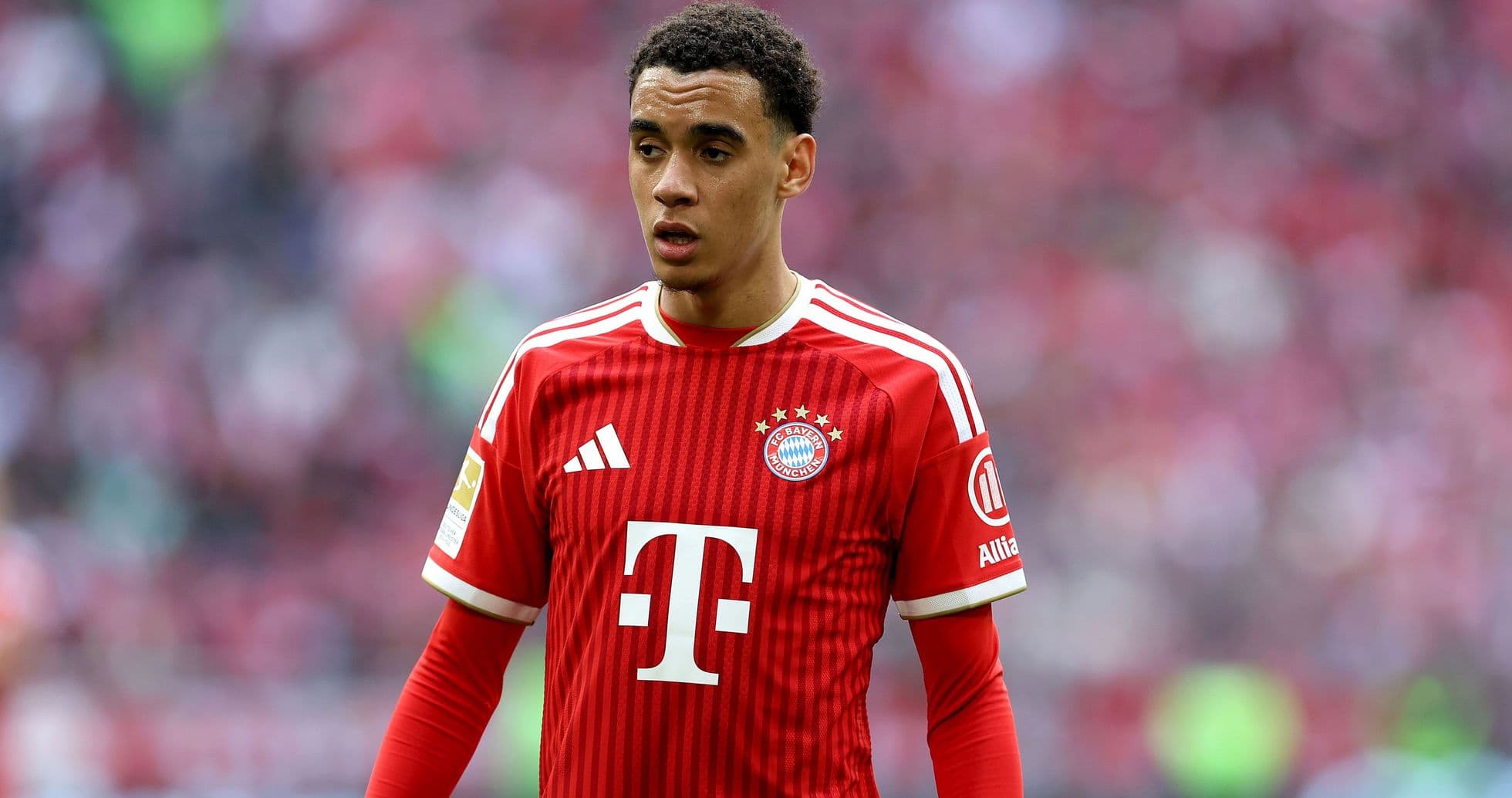 Игрок ФК Bayern München в красной форме на поле