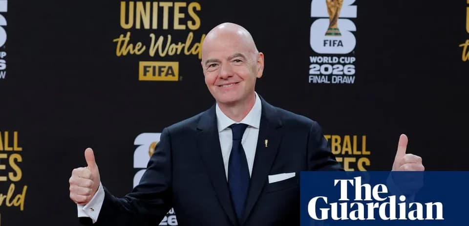 Человек с поднятыми большими пальцами на фоне логотипа FIFA