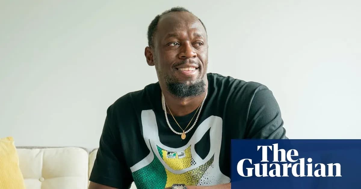 Athlete sitting on sofa, smiling and wearing a t-shirt