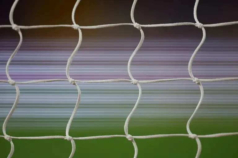 Close-up of soccer goal net with blurred background