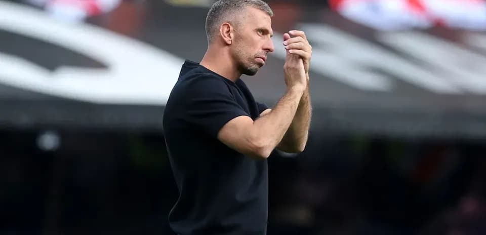 Тренер applauding during a match on the sidelines