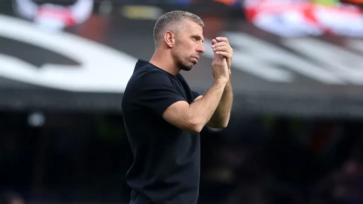 Тренер applauding during a match on the sidelines