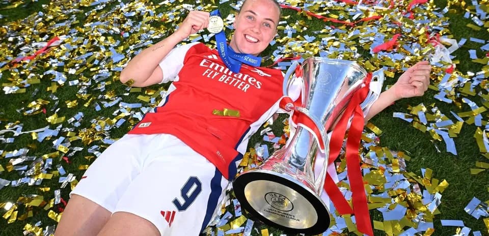 Игрок Арсенала с кубком и медалью на поле