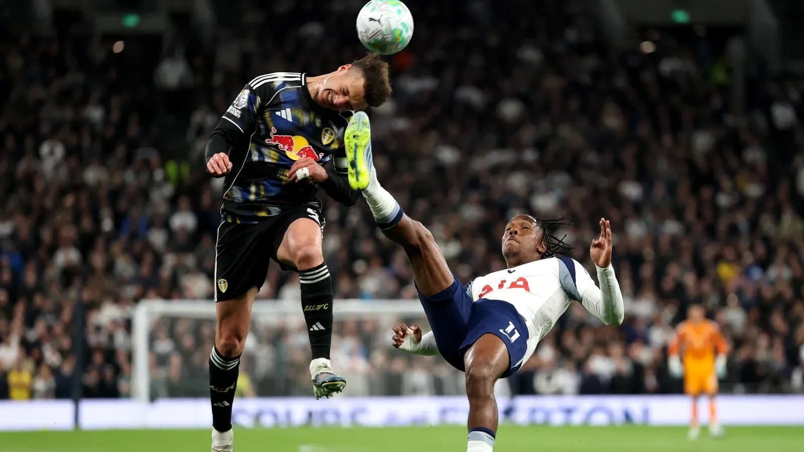 Goalkeeper and player in mid-air collision during match